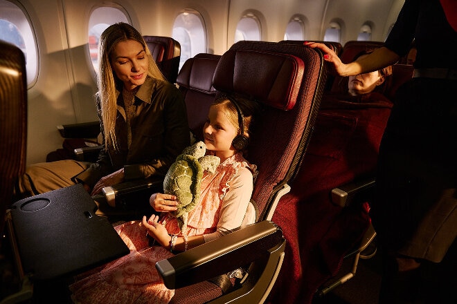 Mother and Daughter inflight entertainment in economy