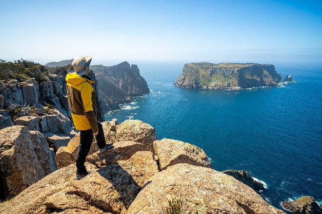 Hiker overlooking the water, Three Cape hike Tasmania