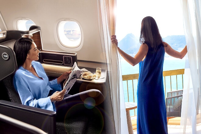 Person sitting onboard an aircraft then looking out of a hotel room window