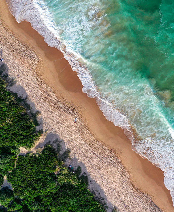 Aerial view of ocean and sand