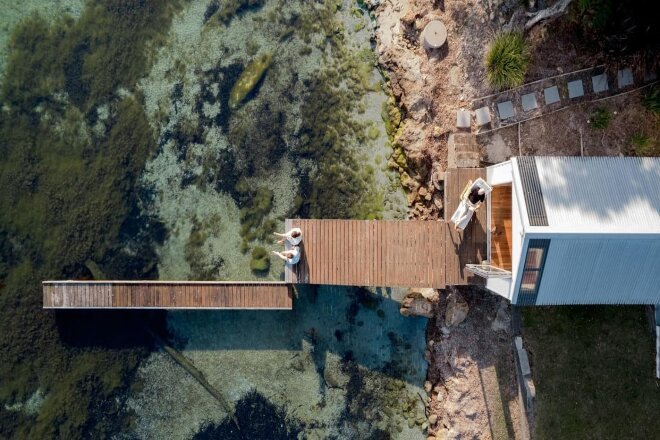 Aerial view of waterfront house and jetty