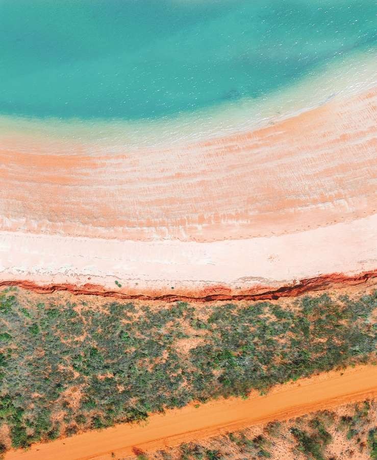 Blue water, red sands and bushland