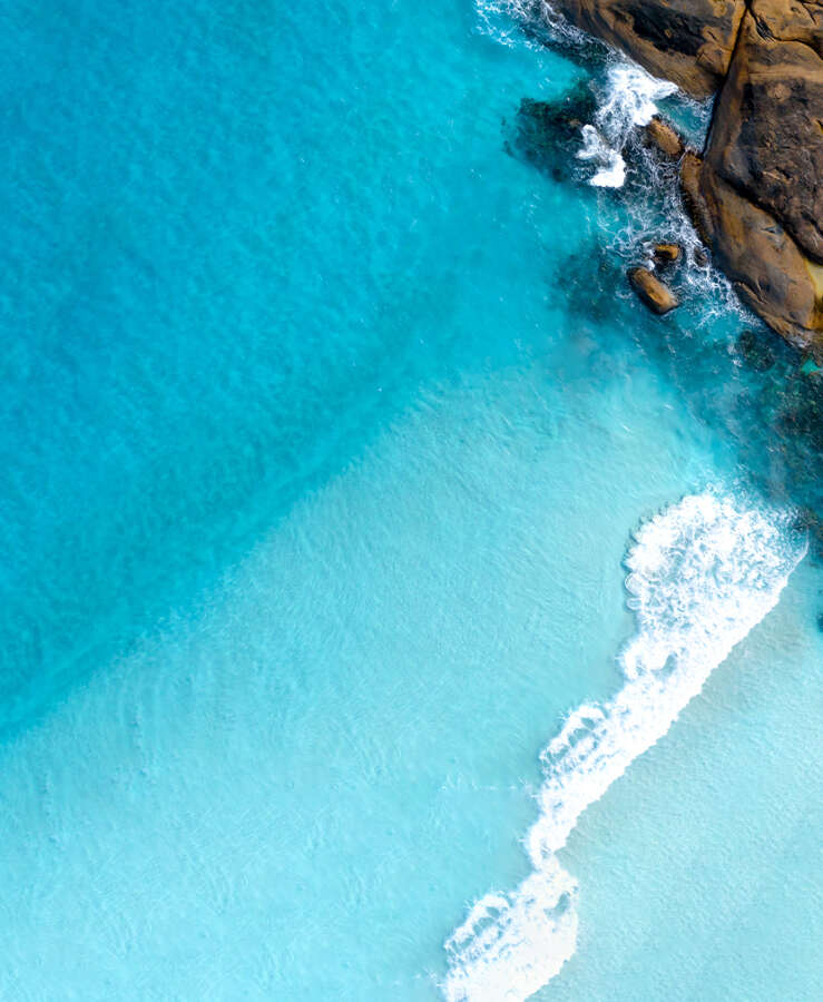 blue ocean next to rocks