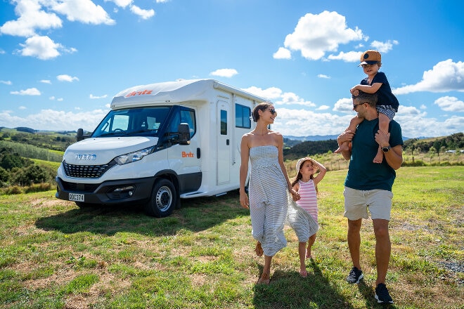 A family exploring the countryside next to a Britz motorhome