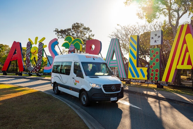 Campervan driving pass an Australian tourism sign in Caboolture