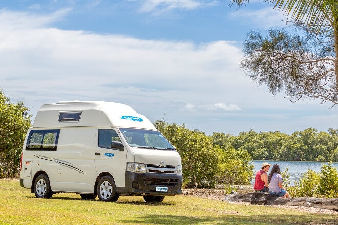 Cheapa Campa van parked in a rest stop next to a lake