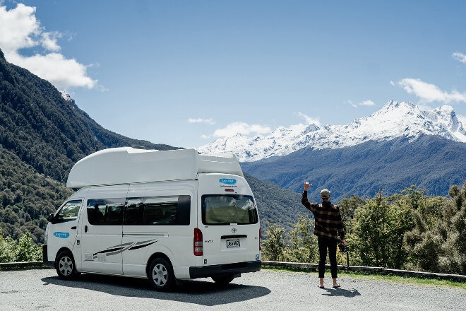 Cheapa Campa van parked in a rest stop with mountain view