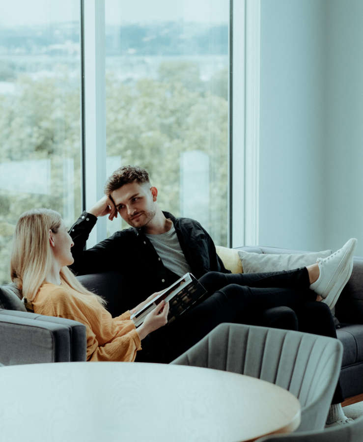 Couple sitting and relaxing on a hotel room sofa