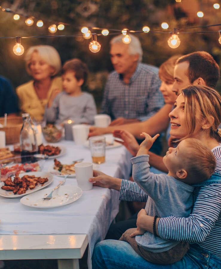 Family having an outdoor celebratory dinner