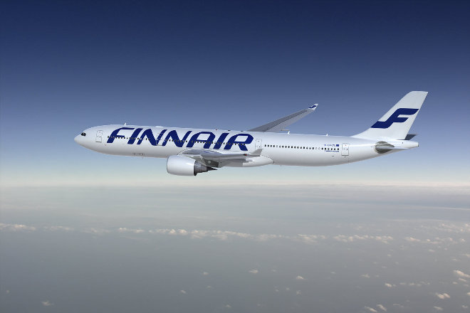 Finnair aircraft flying above clouds