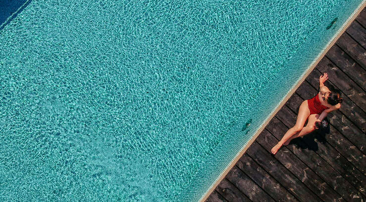 Aerial view of woman poolside