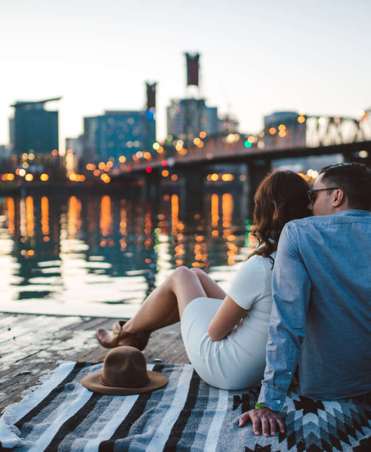 Couple enjoying picnic overlooking city