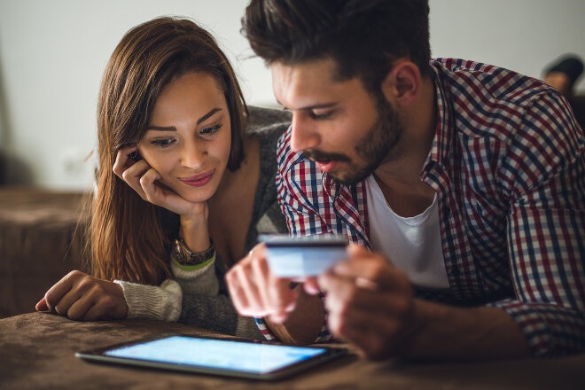 Couple online shopping on their iPad