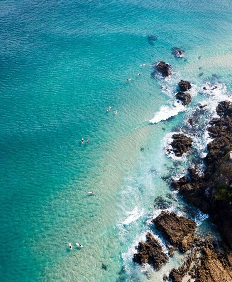 Aerial view of clear blue ocean and rocks