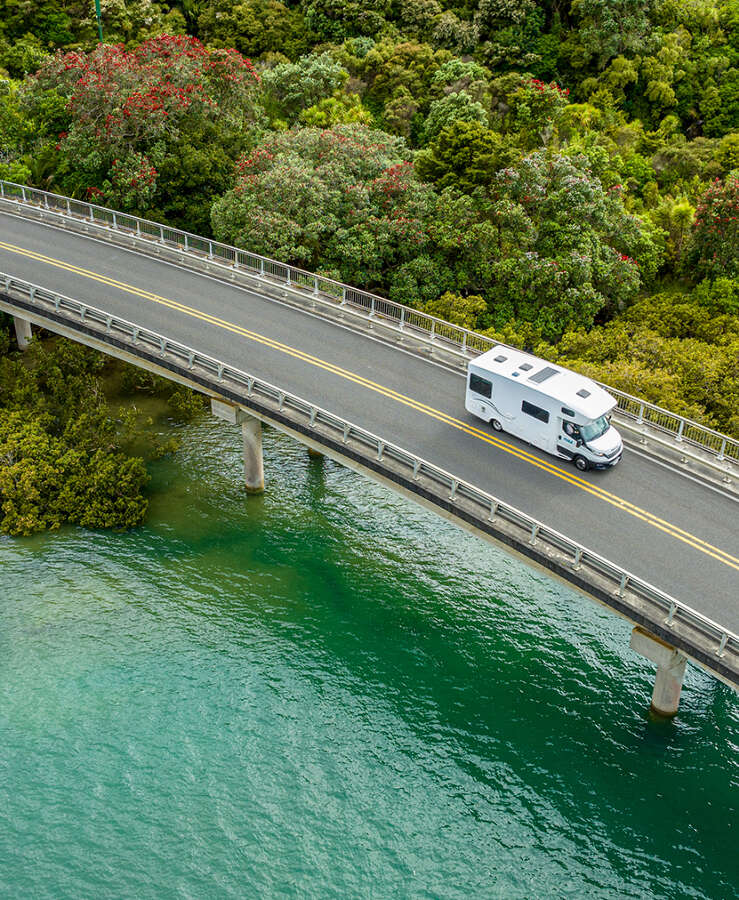 Maui camper driving over a bridge and crystal clear water