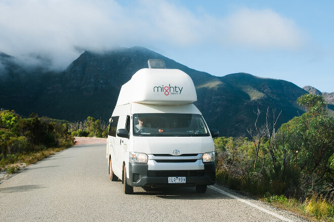 Mighty campervan driving through the countryside