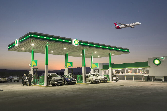 Qantas plane flying overhead a BP petrol station