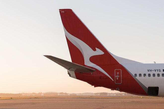 Qantas aircraft tail on tarmac at sunset