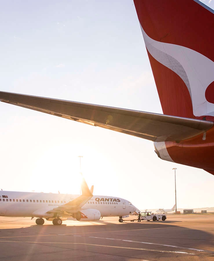 Qantas aircraft on tarmac in sun