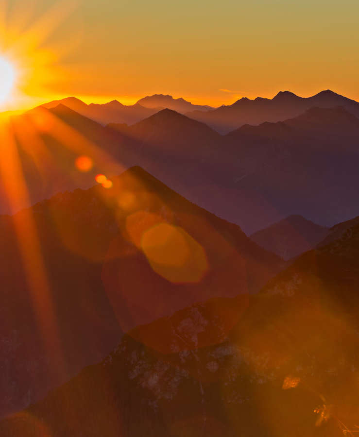 Sun setting over mountains