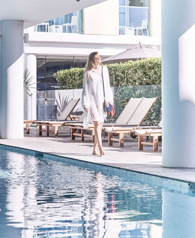 Guest walking past a TFE hotel pool