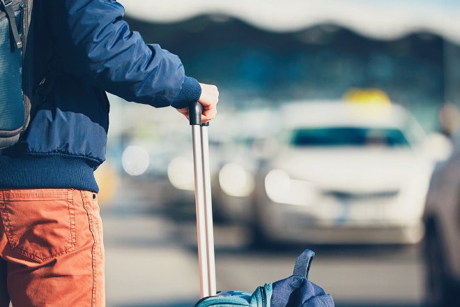 Traveller waiting for uber at airport