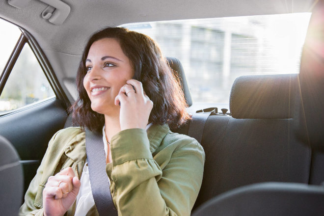 Women in iphone riding in a car