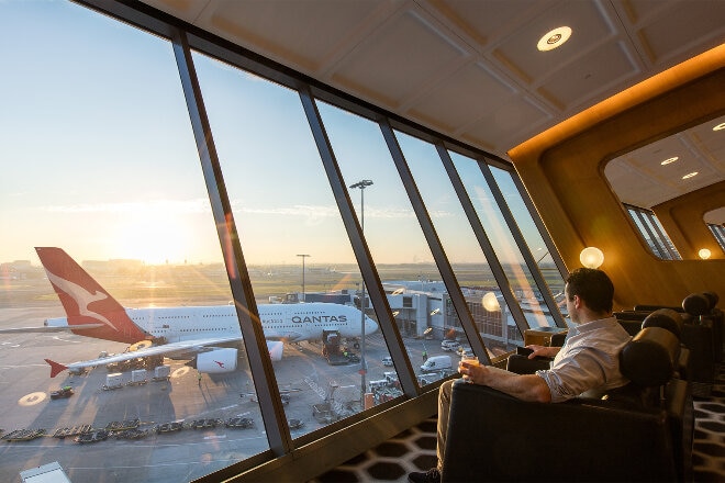 Man looking out the window at the airport lounge