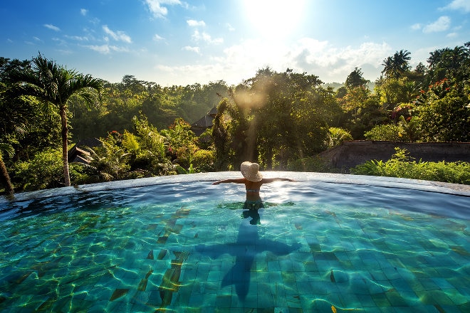 Woman swimming in an infinity pool