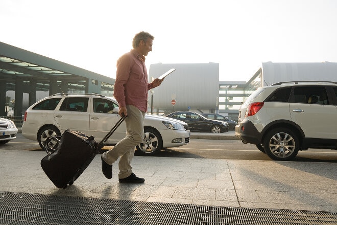 Man walking through airport carpark