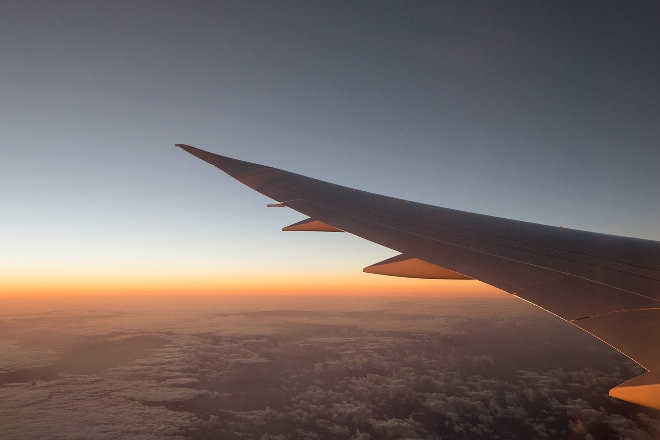 Aircraft wing over clouds