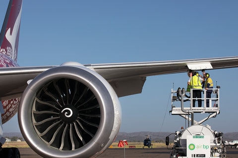 Engineers working underneath the wing of an aircraft