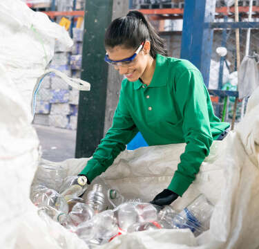 Woman sorting through recycling