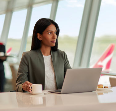 Person on laptop staring out window