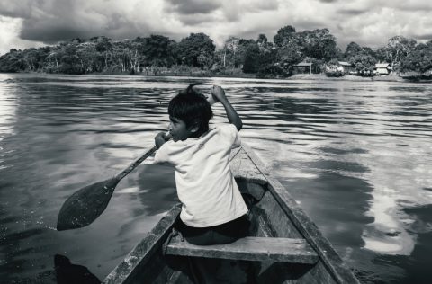 A boy on a boat in the Amazon River