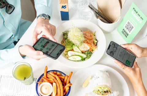 in restaurant flatlay phones app foodini investing in tech amex business