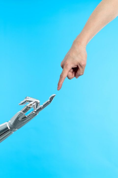 Human hand touching robot finger