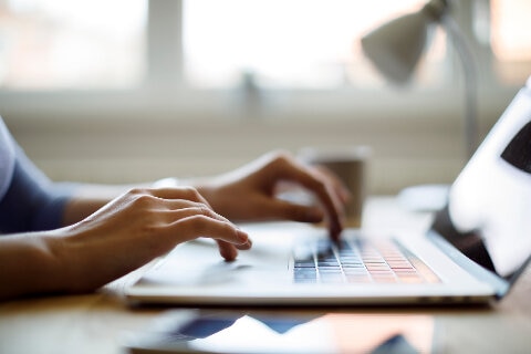 A person typing on a laptop