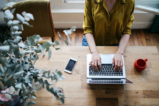 Overhead image of a ladyworking on the laptop