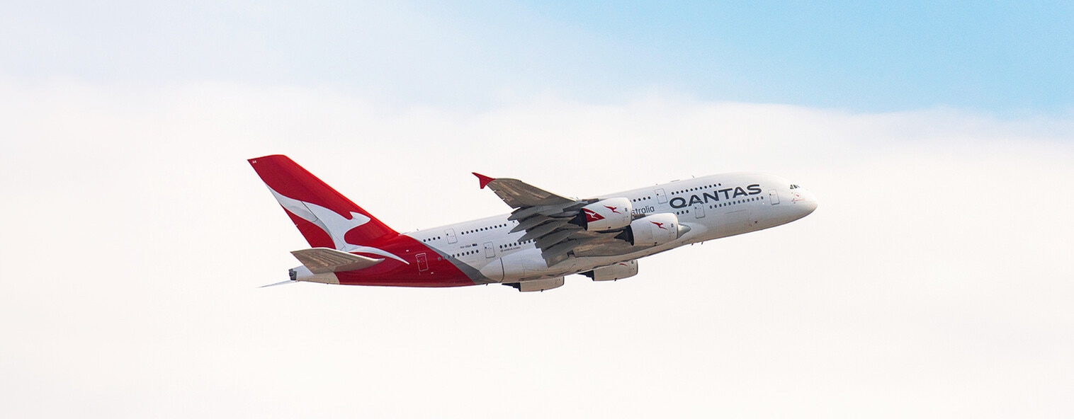 Qantas A380 taking off from Sydney airport on a blue sky day