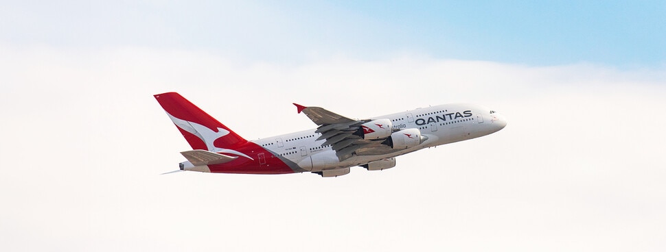 Qantas A380 taking off from Sydney airport on a blue sky day