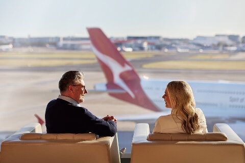 Man and woman are the airport lounge waiting for their flight