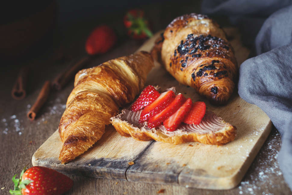 Croissants with chocolate cheese spread and fresh strawberries