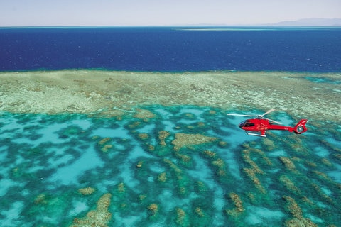 Nautilus helicopter flying over Great Barrier Reef